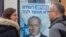 aption People look at a poster of Israel Prime Minister and governing Likud party leader Benjamin Netanyahu at a voting center in the northern Israeli city of Hadera, Dec. 26, 2019. 