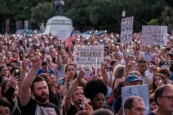 Immigration rights activists hold a "Lights for Liberty" rally and candle light vigil in front of the White House in Washington, July 12, 2019.