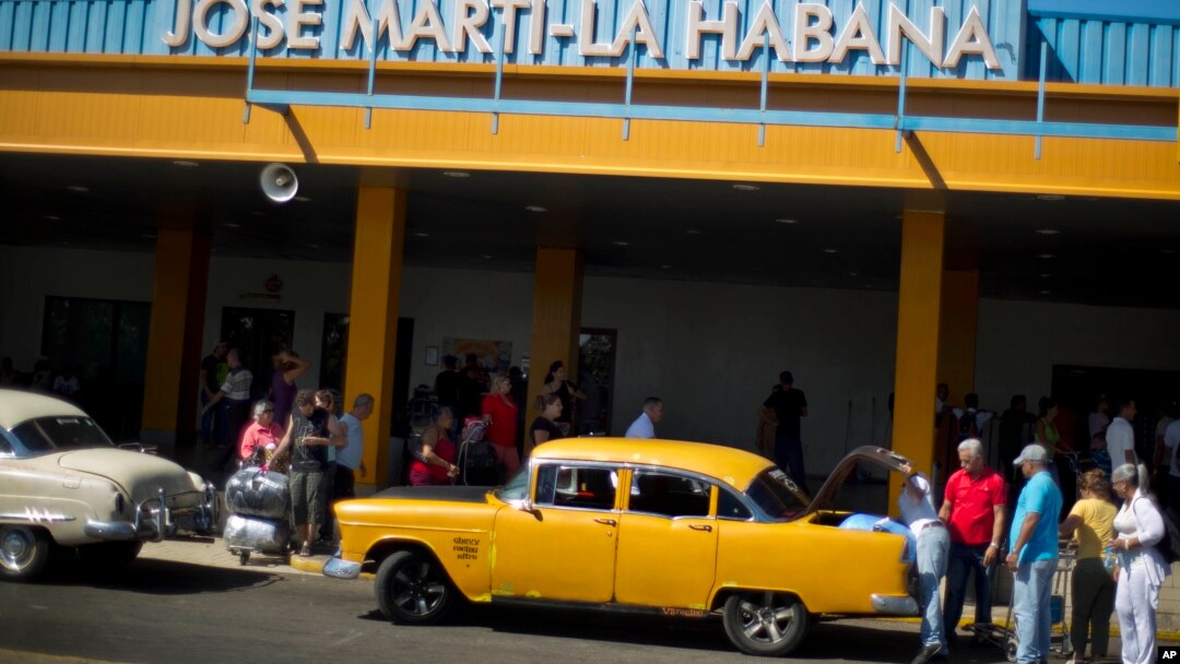 FILE - People put their luggage in a private taxi as they arrive from the U.S. to the Jose Marti International Airport in Havana, Cuba, Sept. 1, 2014. 