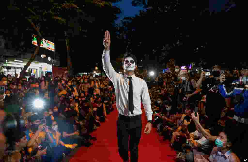 Pro-democracy protesters perform on a mock &quot;red carpet&quot; fashion show billed as a counterpoint to a fashion show being held by one of the monarchy&#39;s princesses nearby in Bangkok, Thailand.