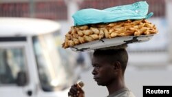 FILE - A man sells samosas at a marketplace in Burundi's capital Bujumbura.