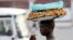 FILE - A man sells samosas at a marketplace in Burundi's capital Bujumbura.