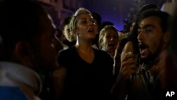 Lebanese anti-government demonstrators shout slogans during a protest against the ongoing trash crisis and government corruption in Beirut, Sept. 9, 2015.