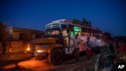 FILE - People who fled the conflict in Ethiopia's Tigray region arrive on a bus at Umm Rakouba refugee camp in Qadarif, Sudan, Nov. 26, 2020. The Ethiopian army announced Nov. 28 that it had taken full control of Mekelle, Tigray's capital.