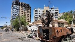 Members of army walk near bombed buildings, as Sudan's army retakes ground in the state of Khartoum, Sudan.