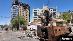 Members of army walk near bombed buildings, as Sudan's army retakes ground in the state of Khartoum, Sudan.