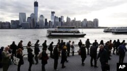 A long line forms at the ferry terminal in Jersey City, N.J., as people commute toward New York City, November 5, 2012. Flooding caused by Superstorm Sandy halted mass transportation in the northern New Jersey region, with train service to New York comple
