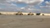 FILE - Military vehicles of U.S. soldiers are seen at the al-Asad air base in Anbar province, Iraq, Jan. 13, 2020. U.S. forces in Iraq and Syria have been attacked with drones or rockets at least 27 times in recent days, a Pentagon spokesman said.