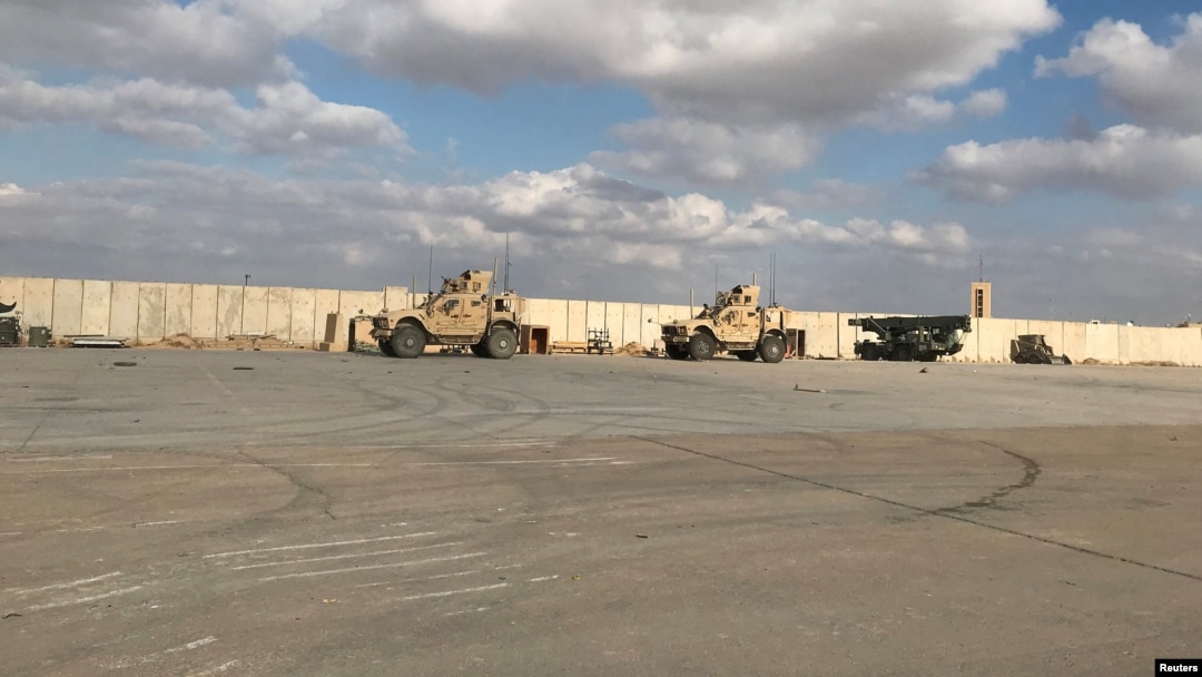FILE - Military vehicles of U.S. soldiers are seen at the al-Asad air base in Anbar province, Iraq, Jan. 13, 2020. U.S. forces in Iraq and Syria have been attacked with drones or rockets at least 27 times in recent days, a Pentagon spokesman said.