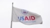 FILE - A USAID flag flutters outside as the USAID building sits closed to employees after a memo was issued freezing funding, in Washington, Feb. 3, 2025.