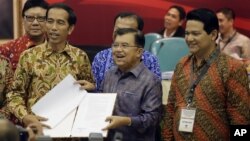 Indonesia President-elect Joko Widodo, left, and his running mate Jusuf Kalla, center.