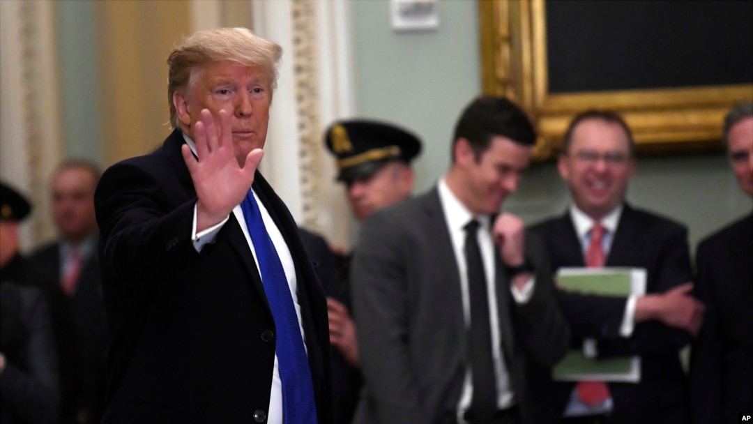 President Trump waves as he leaves after attending the weekly Republican policy luncheon on Capitol Hill in Washington, Tuesday, March 26, 2019.