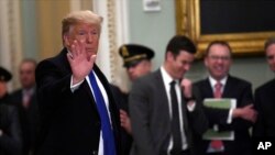 President Trump waves as he leaves after attending the weekly Republican policy luncheon on Capitol Hill in Washington, Tuesday, March 26, 2019.