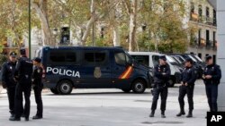 Police officers stand outside the National Court, at right, in Madrid, Spain, Nov. 2, 2017. 