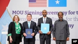 U.S. Assistant Secretary of State for African Affairs Molly Phee, Charge d'Affaires to the U.S. Embassy Shane Dixon, Defense Minister Abdulkadir Mohamed Nur and President Hassan Sheikh Mohamud attend the signing of a security pact in Mogadishu, Somalia, on Feb 15, 2024.