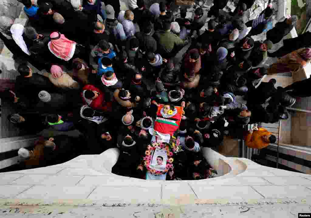 Mourners carry the body of Palestinian Mosab al-Tamimi, 17, who was killed during a confrontation between Israeli troops and Palestinian stone-throwing protesters, during his funeral near the West Bank city of Ramallah.