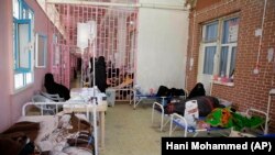 In this March 30, 2019 file photo, women are treated for suspected cholera infection at Al-Sabeen hospital, in Sanaa, Yemen.