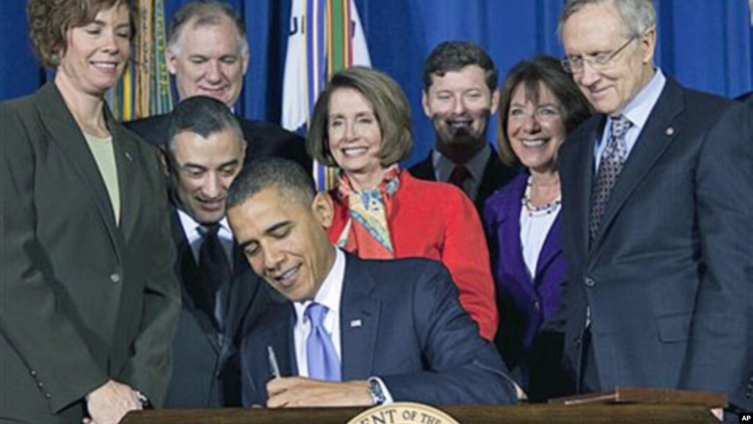 FILE - Lawmakers and supporters look on as President Barack Obama signs legislation to repeal the "Don't Ask, Don't Tell" policy and allow gays to serve openly in the military in Washington, Dec. 22, 2010.