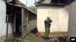 A Russian special forces trooper stands amidst the rubble following a major police operation in Khasavyurt, Dagestan, near the border with Chechnya (file photo)