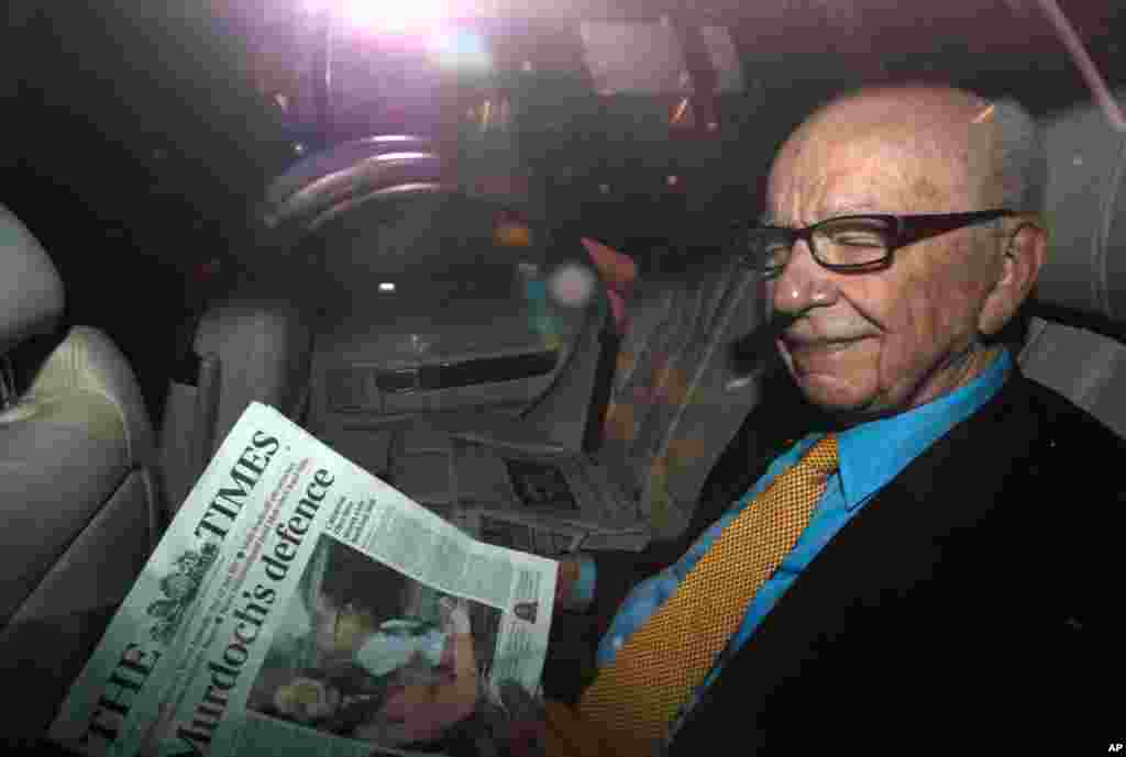 July 20: News Corp Chief Executive and Chairman Rupert Murdoch holds a copy of The Times newspaper as he leaves his home in London. Murdoch has told staff in an email the company is taking steps to ensure serious problems never happen again there and that