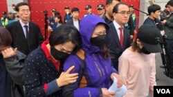 (FILE) The mother of a detained North Korean defector attends a protest outside China’s embassy in Seoul, South Korea.