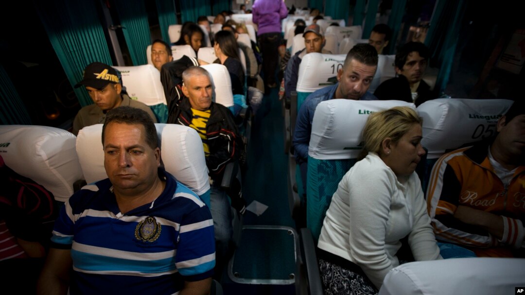 Cuban migrants wait on a bus in Ciudad Pedro De Alvarado, Guatemala, at the border with El Salvador, Wednesday, Jan. 13, 2016, as they continue on their journey to the United States. After more than three months stranded in Costa Rica, 180 of the 8,000 Cuban migrants were flown to El Salvador, and then traveled by land to Guatemala as part of a regional agreement to overcome Nicaragua's refusal to let them through by land.
