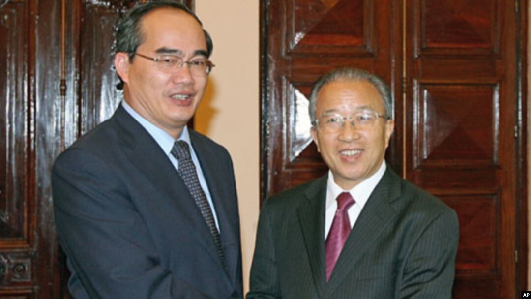 Vietnam's Deputy Prime Minister Nguyen Thien Nhan (L) poses with China's State Councilor Dai Bingguo - days after China dispatched a fishing enforcement ship to the disputed Paracel Islands in a move raising tension with rival claimant Vietnam - at the Go