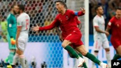 Portugal's Cristiano Ronaldo celebrates after he scored his third goal with a free kick during a group B draw, 3-3, with Spain at the 2018 World Cup in the Fisht Stadium in Sochi, Russia, June 15, 2018. 