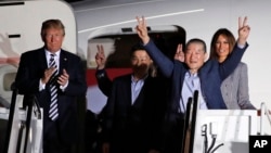 President Donald Trump and first lady Melania Trump greet former North Korean detainees Kim Dong Chul, second right, Tony Kim, center, and Kim Hak Song, behind Tony Kim, upon their arrival, Thursday, May 10, 2018, at Andrews Air Force Base, Md. (AP Photo/Alex Brandon)