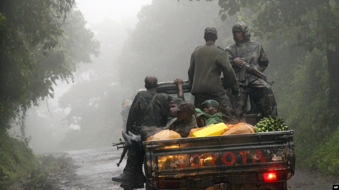 Congolese M23 rebels carry goods in the back of a truck near the Congo-Uganda border town of Bunagana, DRC, December 5, 2012.