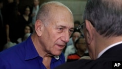 Israel's former Prime Minister Ehud Olmert speaks to a lawyer upon his arrival at the Tel Aviv District Court in Israel, Tuesday, May 13, 2014. Olmert was sentenced on Tuesday to six years in prison for his role in wide-ranging bribery case, capping a stu