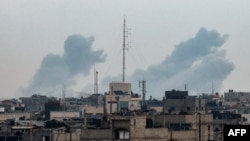 This picture taken from Rafah shows smoke billowing over Khan Yunis in the southern Gaza Strip during Israeli bombardment on Feb.y 20, 2024, amid continuing battles between Israel and the Palestinian militant group Hamas.