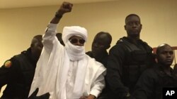 L'ancien Hissène Habre met sa main en l'air lors de son procès à Dakar, Sénégal, le 30 mai 2016. 