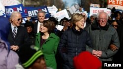 Seven of the Democratic US Presidential candidates including former U.S. Vice President Joe Biden, Sen. Amy Klobuchar, Sen. Elizabeth Warren and Sen. Bernie Sanders, walk arm-in-arm with local African-American leaders during the Martin Luther King…