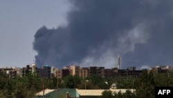 (FILES) Smoke billows over buildings in Khartoum on May 1, 2023 as deadly clashes between rival generals' forces have entered their third week.