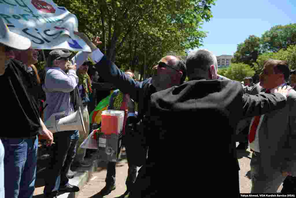 Seorang demonstran pro-Turki mencoba merobek poster dari tangan seorang demonstran pro-Kurdi di luar Gedung Putih, di mana Presiden AS Donald Trump sedang bertemu dengan Presiden Turki Recep Tayyip Erdogan, 16 Mei 2017.