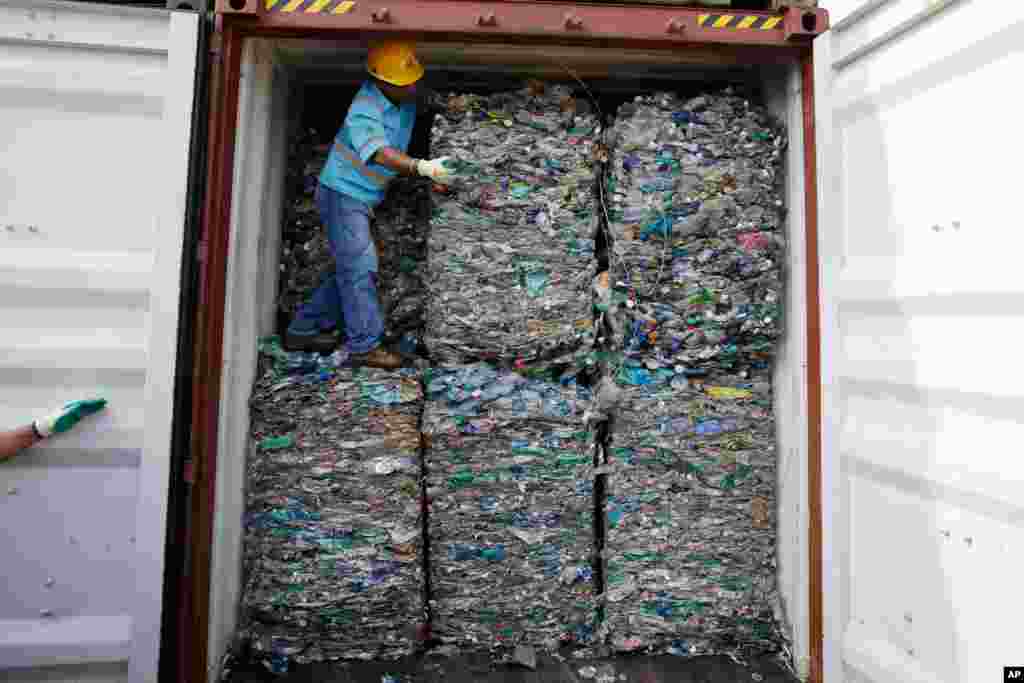 A worker stands inside a container full of plastic waste at Tanjung Priok port in Jakarta, Indonesia. Indonesia is sending hundreds of containers of waste back to Western nations after finding they were contaminated with hazardous materias.