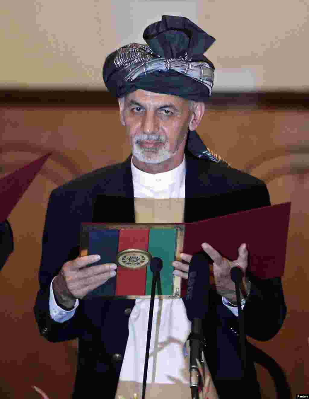 Newly-elected President Ashraf Ghani takes the oath during his inauguration in Kabul, Sept. 29, 2014.