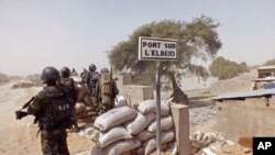 FILE- Cameroon soldiers stand guard at a lookout post as they take part in operations against the Islamic extremists group Boko Haram near the village of Fotokol, Feb. 25, 2015. 