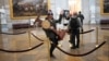 WASHINGTON, DC - JANUARY 06: A pro-Trump protester carries the lectern of U.S. Speaker of the House Nancy Pelosi through the Roturnda of the U.S. Capitol Building after a pro-Trump mob stormed the building on January 06, 2021 in Washington, DC…