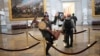 WASHINGTON, DC - JANUARY 06: A pro-Trump protester carries the lectern of U.S. Speaker of the House Nancy Pelosi through the Roturnda of the U.S. Capitol Building after a pro-Trump mob stormed the building on January 06, 2021 in Washington, DC…