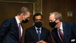 FireEye CEO Kevin Mandia, SolarWinds CEO Sudhakar Ramakrishna and Microsoft President Brad Smith talk to each other before a Senate Intelligence Committee hearing on Capitol Hill on Feb. 23, 2021 in Washington.