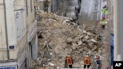 Firefighters work at the scene where buildings collapsed in Marseille, southern France, Nov. 5, 2018.