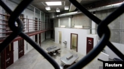  FILE - The interior of an unoccupied communal cellblock is seen at Camp VI, a prison used to house detainees at the U.S. Naval Base at Guantanamo Bay, March 5, 2013.