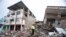 A police officer stands on debris, next to buildings destroyed by an earthquake in Pedernales, Ecuador, April 17, 2016.&nbsp;The earthquake flattened buildings and buckled highways along its Pacific coast, sending the Andean nation into a state of emergency.