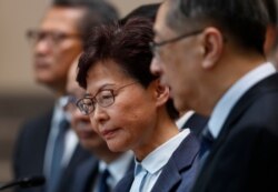 FILE - Hong Kong Chief Executive Carrie Lam, center, reacts during a press conference in Hong Kong, July 22, 2019.