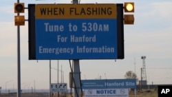 An emergency sign flashes by the Hanford Nuclear Reservation, May 9, 2017, in Richland, Wash. A portion of an underground tunnel containing rail cars filled with radioactive waste collapsed at a sprawling storage facility in a remote area of Washington state, forcing an evacuation of some workers at the site. 