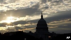 The Sun rising over the U.S. Capitol, Washington, D.C. (undated file photo).