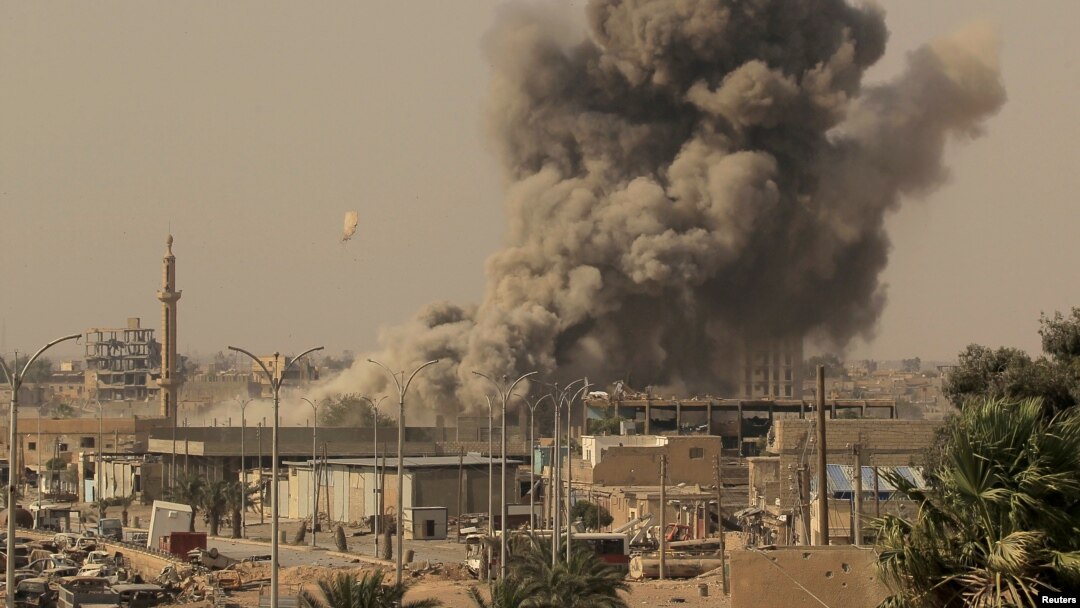 FILE - Smoke rises after an airstrike during fighting between members of the Syrian Democratic Forces and Islamic State militants in Raqqa, Syria, Aug. 15, 2017. U.S. military and intelligence officials say IS's fortunes may be starting to rebound in Syria and Iraq.