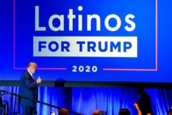 FILE - President Donald Trump give a thumbs up to the cheering crowd after a Latinos for Trump Coalition roundtable in Phoenix, Arizona, Sept. 14, 2020.